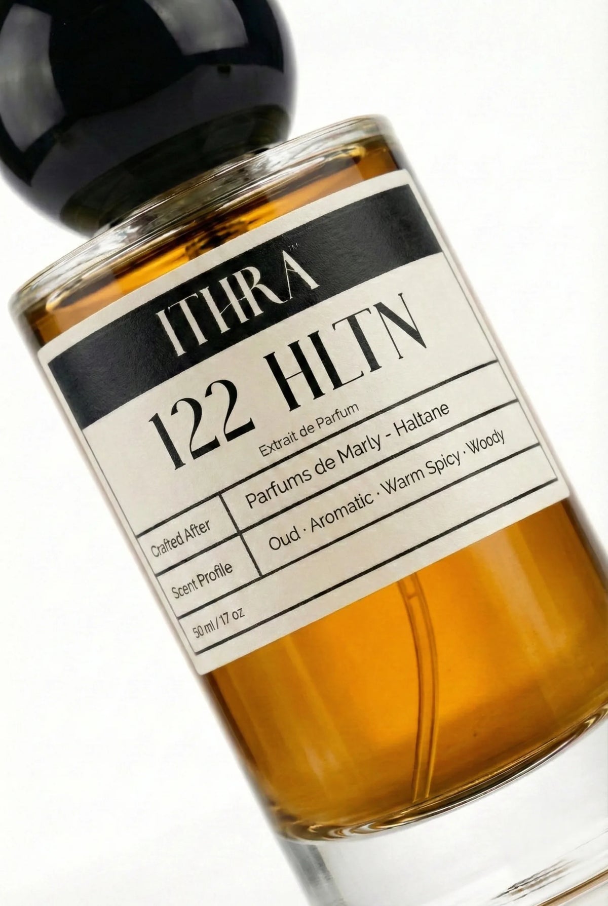 Close-up of 122 HLTN perfume label by Ithra, warm spicy aromatic oud cedar woody men's perfume, available in 50ml and 100ml